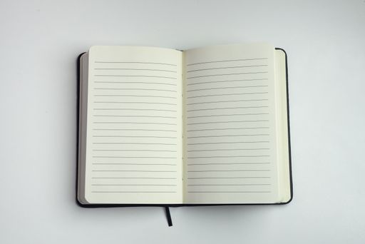 Opened notebook with empty white sheets with horizontal lines with a white background