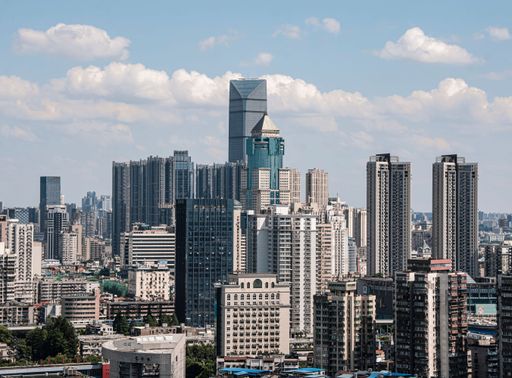 Modern skyscrapers cluster under a blue sky in Wuhan Financial District, China