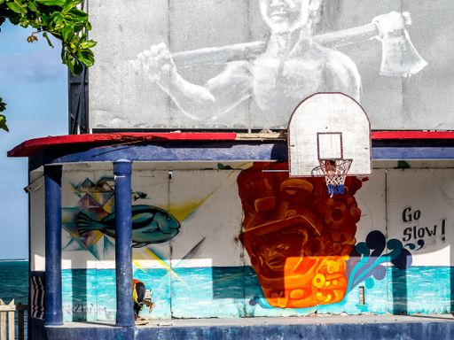 A view of a basketball area with street art in Caye Caulker, Be