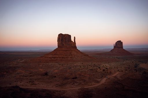 A beautiful view of Monument Valley against a colorful sunset sky at the Arizona-Utah state line in USA