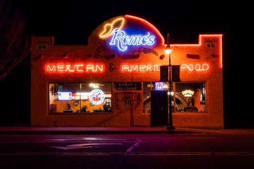 A closeup of a Mexican restaurant at night with glowing neon signs in Holbrook, Arizona.
