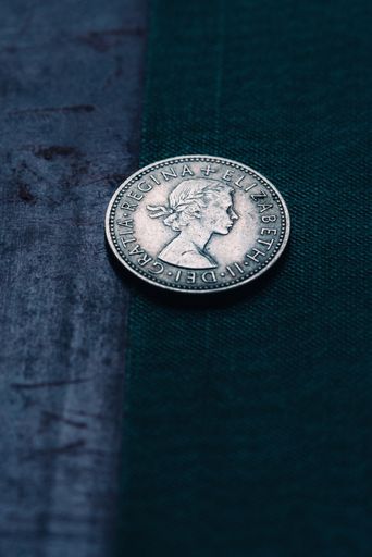 A closeup of an old English shilling on a dark background
