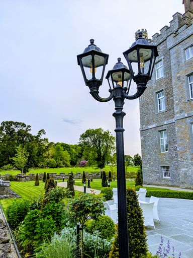A street lantern at a beautiful garden on a sunny day
