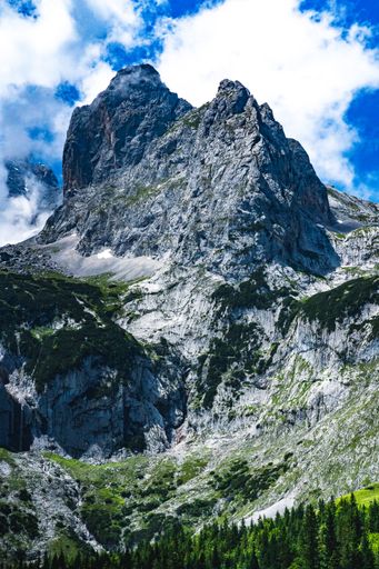 A vertical shot of a magnificent mountain view with jagged peaks
