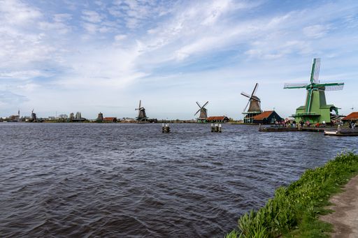 A scenic view of Zaanse Schans, a historic mill village with centuries-old windmills and timber houses