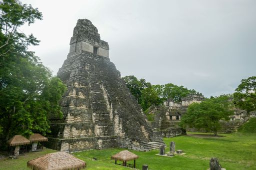 The ancient Mayan ruins of Tikal in Guatemala, featuring the iconic Temple I pyramid surrounded by lush greenery.