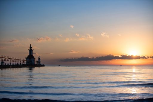 A scenic view of Saint Joseph Pier at sunset with vibrant colors in Saint Joseph, Michigan