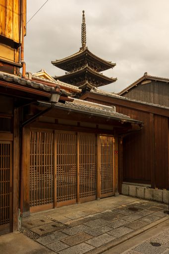 Traditional Hokan-ji Temple, with a view of the Yasaka Pagoda in Kyoto, Japan, under a cloudy sky.