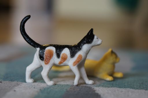 A closeup shot of toys of cats next to each other