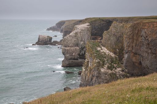 A view of rugged cliffs and sea on a cloudy day. Pembrokeshire Coast National Park, Wales