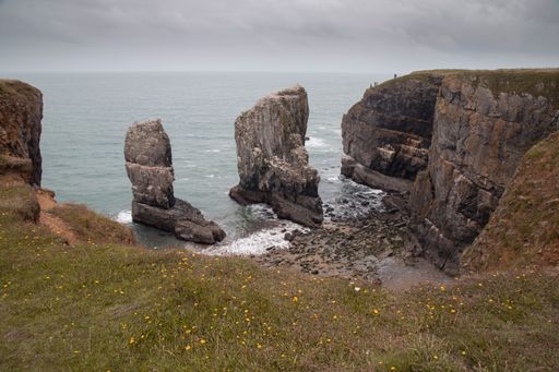 The view of rugged cliffs and sea on a cloudy day. Pembrokeshire Coast National Park, Wales