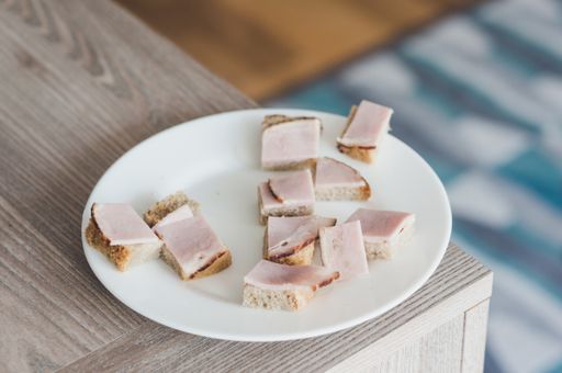A closeup shot of ham on bread in a plate