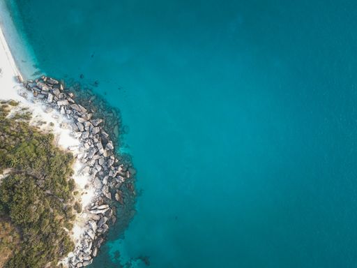 Aerial view of a beautiful beach with clear turquoise waters and rocky coastline on Zakynthos Island, West Coast