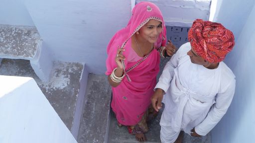 Cute young newlyweds in traditional Indian clothes walking together outdoor