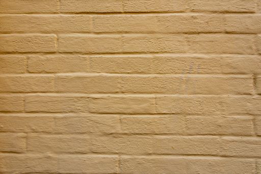 A closeup view of the rough texture of the brown  brick wall