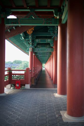 A vertical shot of Woljeonggyo Bridge with red columns and intricate designs at Gyeongju National Museum in Gyeongju, South Korea