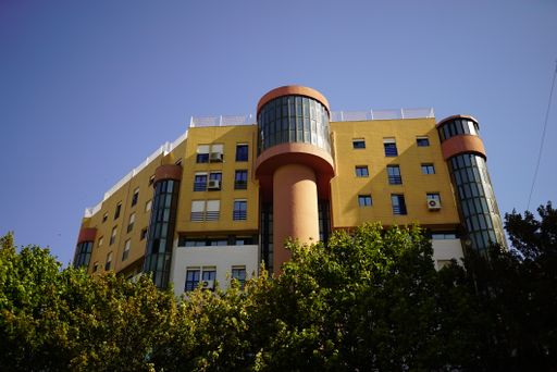 A low angle view of a modern building facade in the blue sky background, Lisbon, Portugal