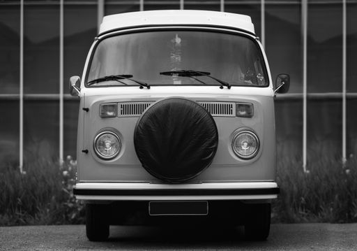 A grayscale shot of a retro vintage classic car