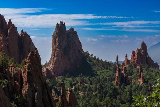 A stunning landscape of the Garden of the Gods with towering red rock formations under a clear blue sky in Colorado Springs.