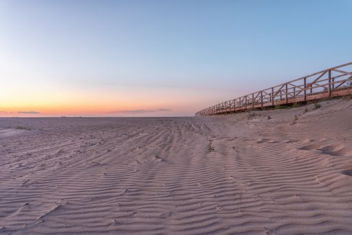 A beautiful shot of a sunset over the sandy seashore