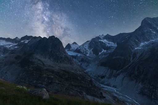 Night landscape view of the milky way above a Swiss mountain range and a glacier's valley, shot at Ferpecle in Wallis Switzerland
