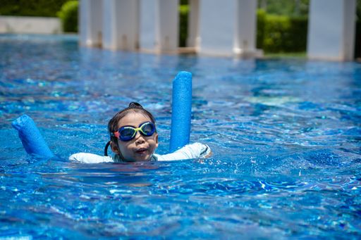 A closeup shot of an Asian child on a swimming pool