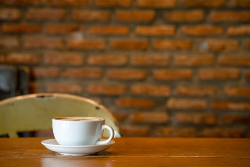A cup of hot frothy cappuccino on a table