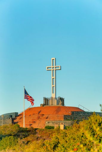 A vertical shot of Mount Soledad Cross against a clear blue sky, La Jolla, California, United States.