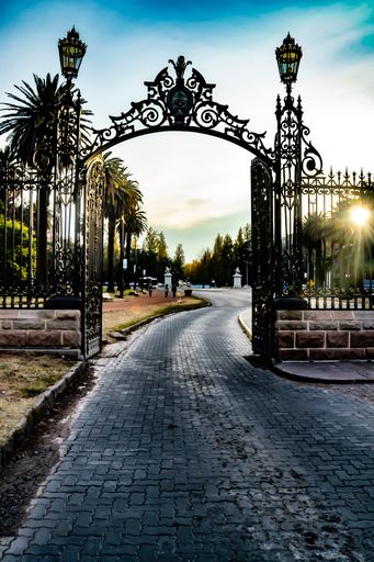 An open metal gate to a park