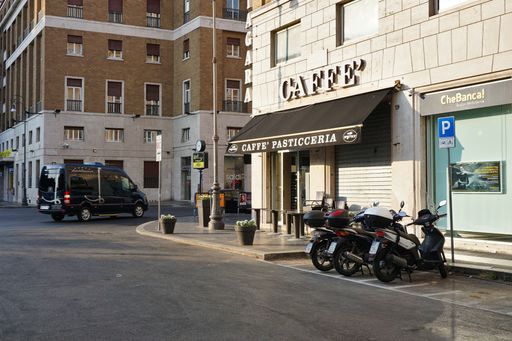 A closeup shot of bikes parked near the cafe in Rome, Italy in the morning