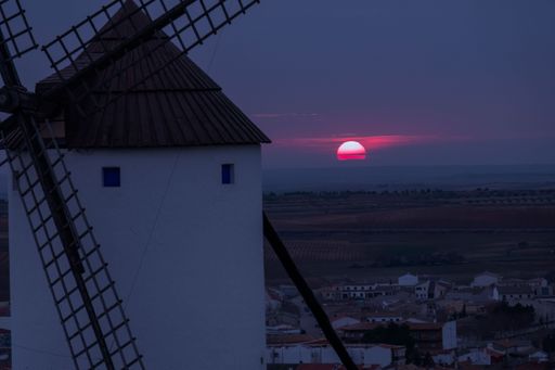 A scenic sunset view of Manchego windmill in Mota del Cuervo, Cuenca, Spain