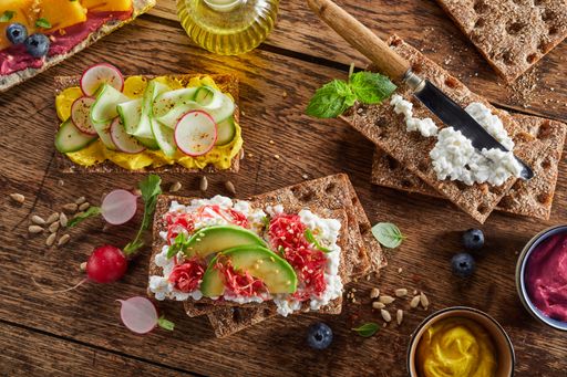 A top view shot of an arrangement of various delicious crispbread toasts with vegetables
