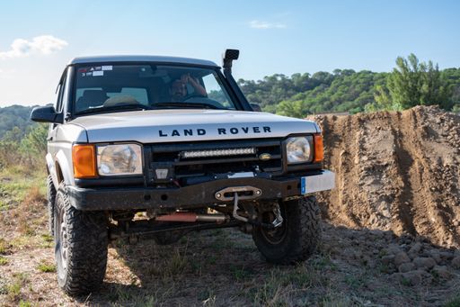 Frontal close-up of a classic british off-road vehicle, the second generation Land Rover Discovery Series II L318 modified for the countryside