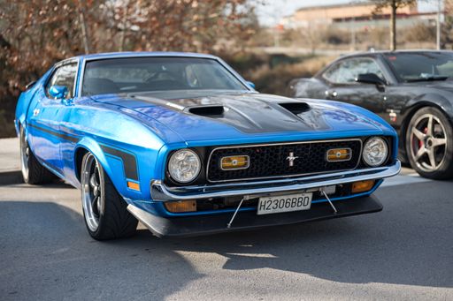 Front view of a classic American sports car Ford Mustang Mach 1 1971 first generation facelift, it is blue with black stripes