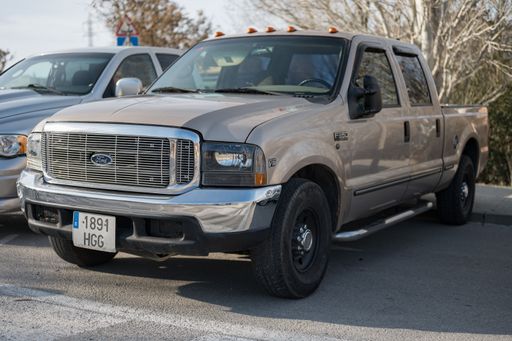 Front view of an old American double cab pickup truck, the first generation brown Ford F-Series F-350 Super Duty