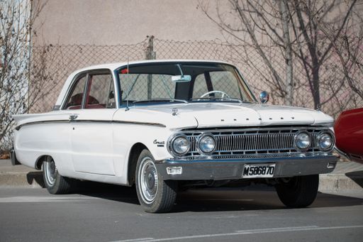 Frontal view of a classic white American car Mercury Comet first generation 1960 - 1963 parked on the street