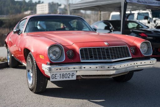 Front view of an old rusty red second generation American Chevrolet Camaro sports car