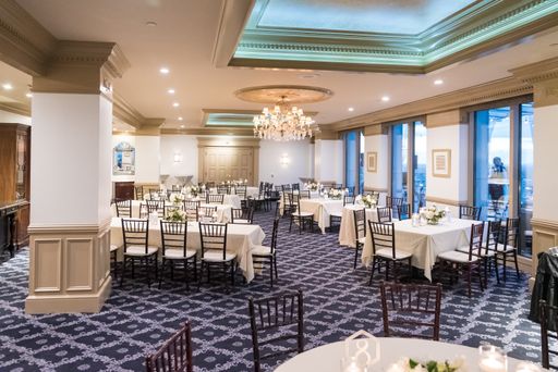 The hall of an elegant restaurant with white tablecloths on the tables