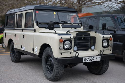 Vehicle made in Spain, the Land Rover Santana Series III in off-white or sand color. with black details and protective grille on the headlights