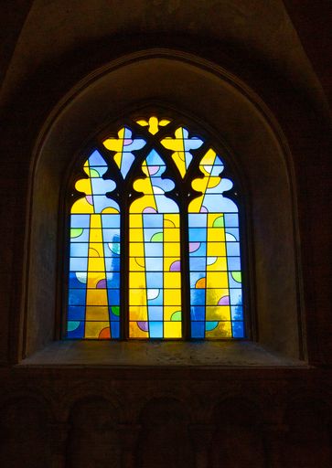 A vertical shot of modern stain glass windows in Norwich Cathedral, the United Kingdom