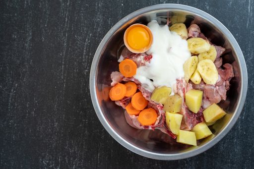 An overhead shot of dish ingredients in a metal bowl ready for cooking