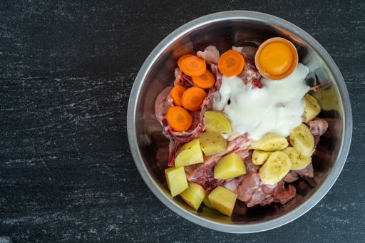 An overhead shot of dish ingredients in a metal bowl ready for cooking