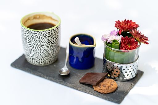A coffee set with cookies and flowers isolated on a white background