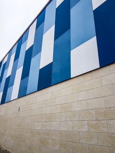 A vertical shot of a building with an abstract design
