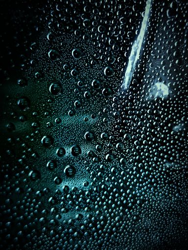 Many raindrops on a glass window
