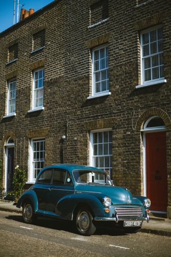 An old vintage car parked near Waterloo Station in London.