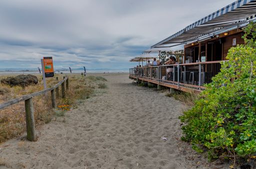 access way for walking to the sandy Sumner beach and sea and alongside the Beach Bar where people dine and drink
