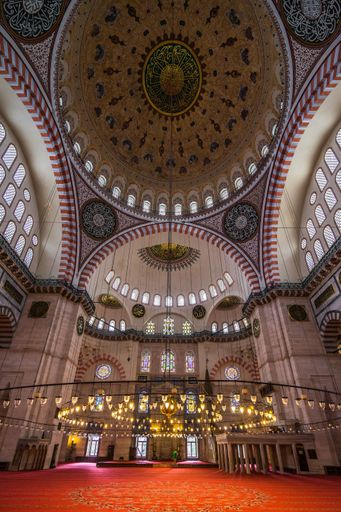 A vertical low angle view of the hall and the ceiling of the Suleymaniye Mosque in Istanbul in Turkey
