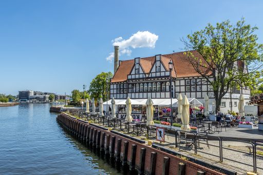A beautiful shot of a river on buildings background in Gdansk, Poland