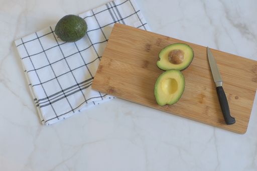 A сloseup of sliced avocado on a wooden board. Top view.